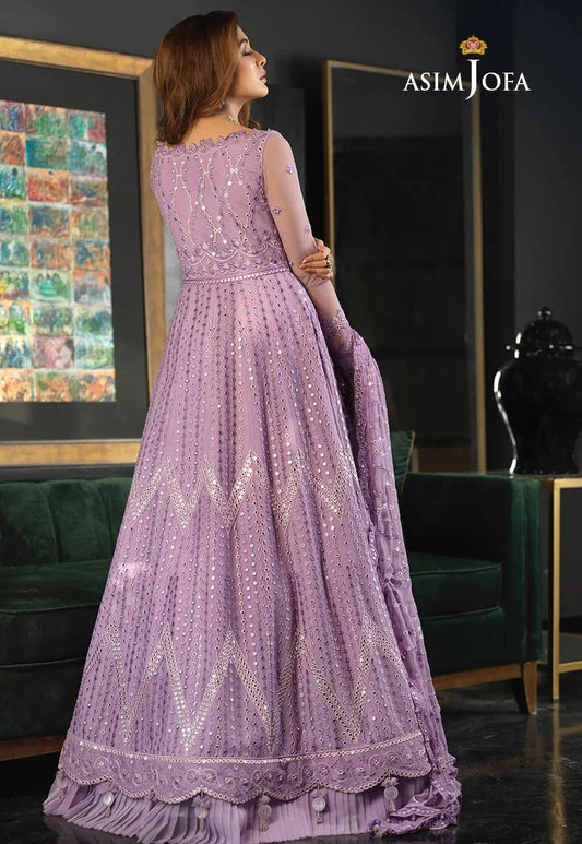 Asim Jofa Maxi Most BEautiful Purple wearing a purple embroidered dress in a room with green furniture and a painting.