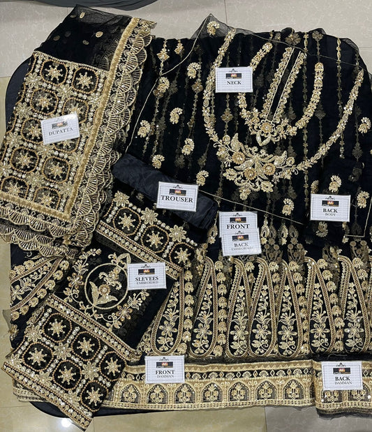 Black embroidered saree with gold details on a flat surface