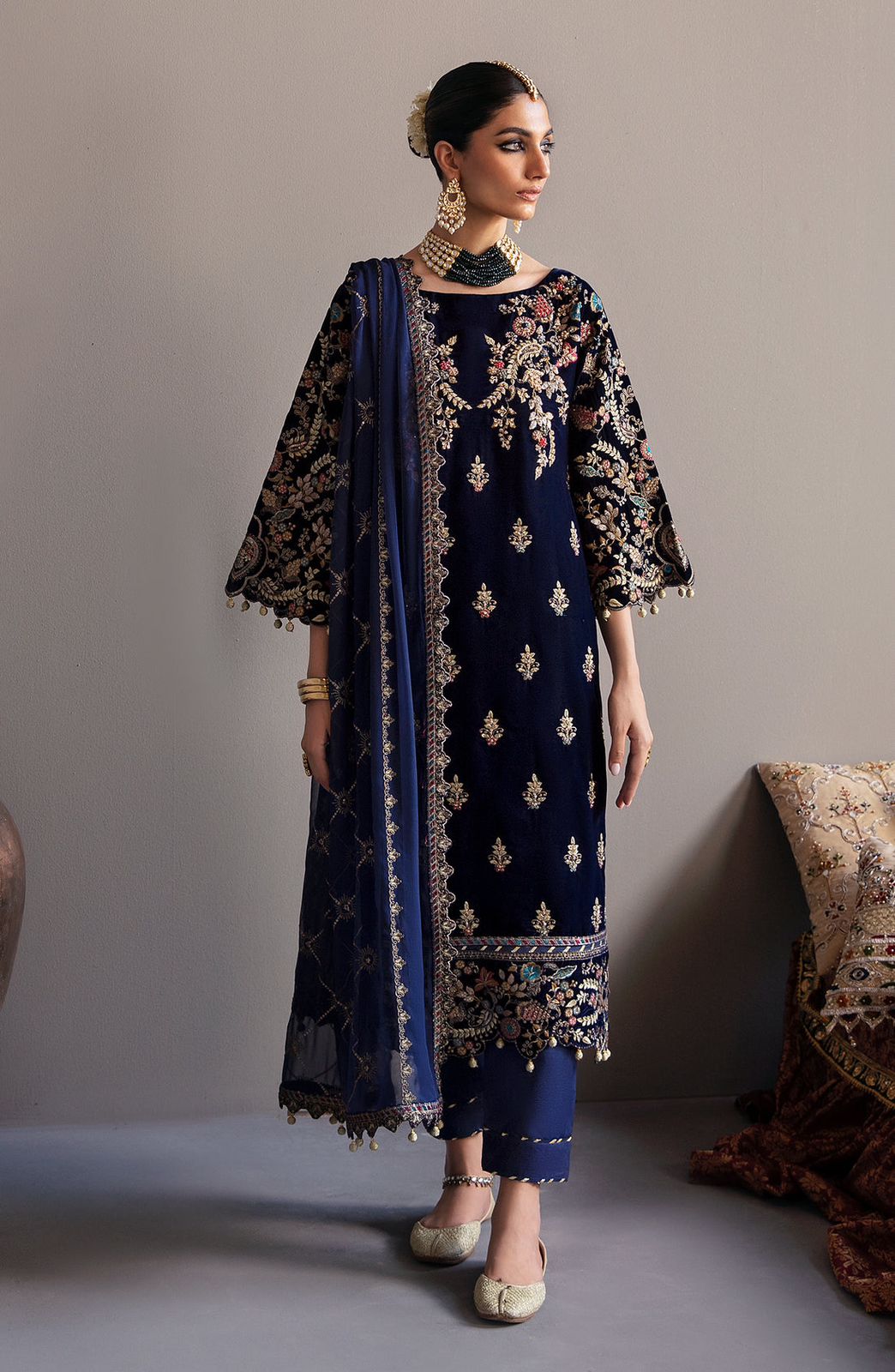 Emaan Adeel Velvet wearing a navy blue embroidered outfit with a matching dupatta against a neutral background