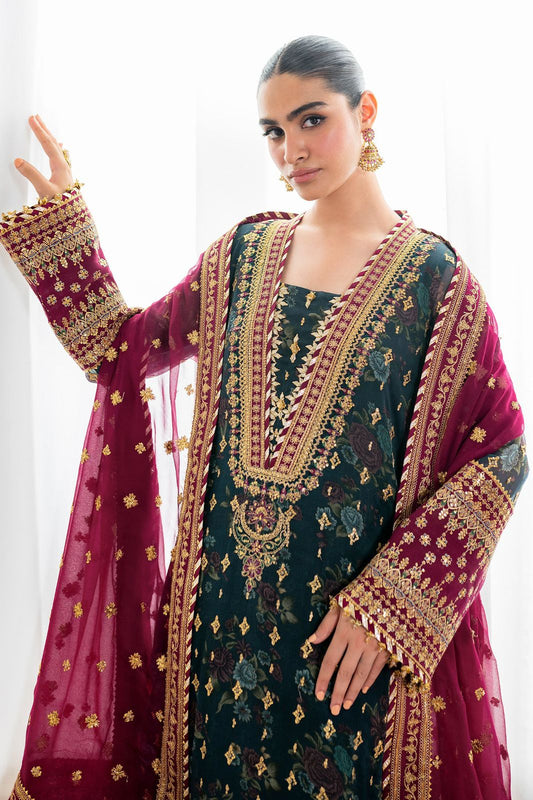 Baroque Bridal Green wearing a traditional embroidered outfit with a maroon dupatta against a white background