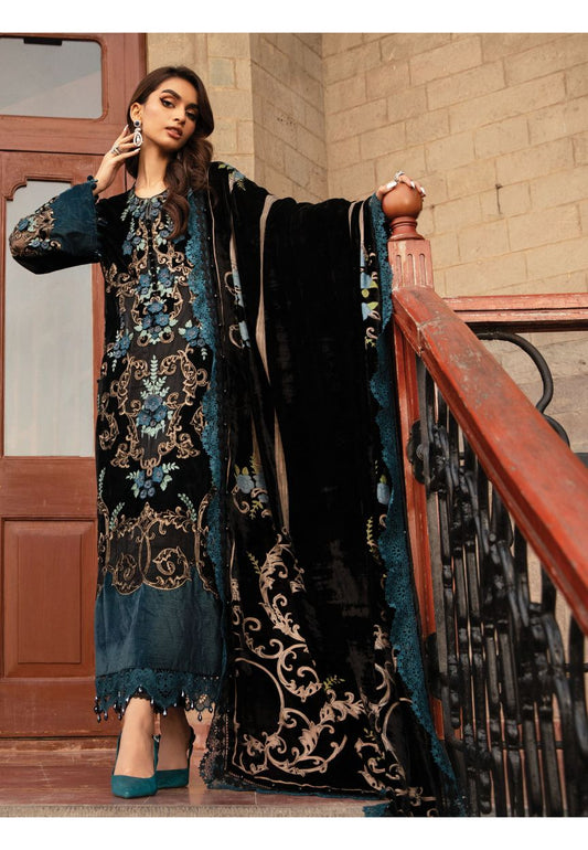 MAria b Palachi VElvet Dress Wedding in a black and blue embroidered outfit standing on a staircase.