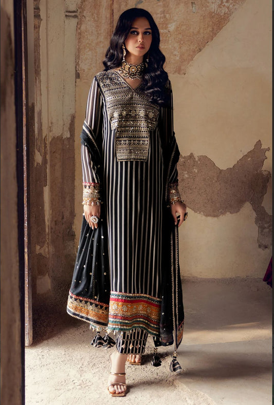 Woman wearing a traditional outfit with intricate patterns in a rustic setting