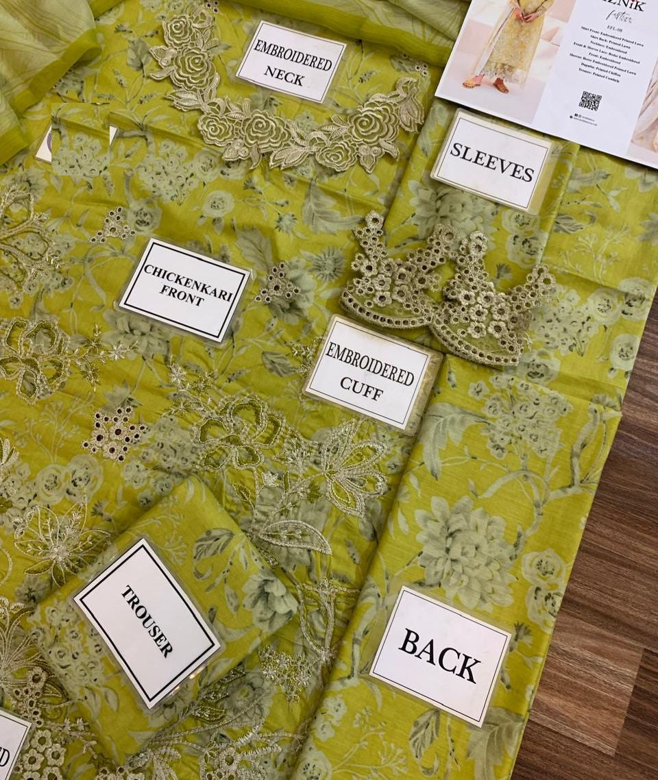 Yellow fabric with embroidered patterns and labels on a wooden surface