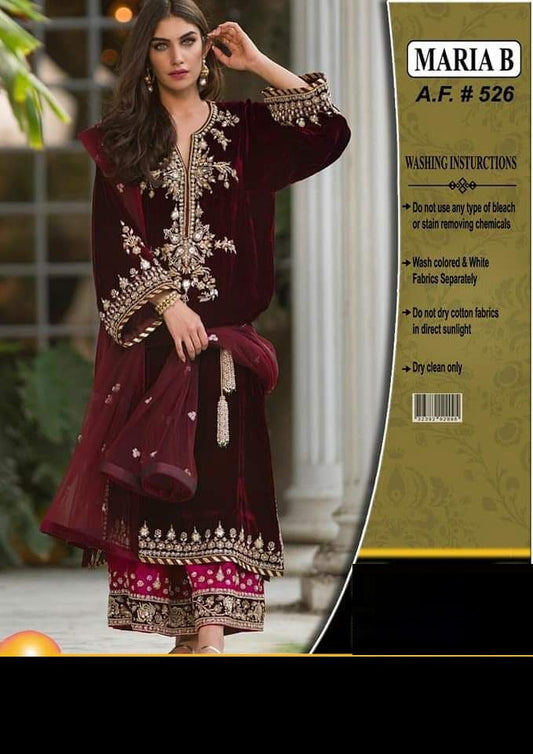 Maroon embroidered traditional outfit with 'Maria B' packaging on the right.