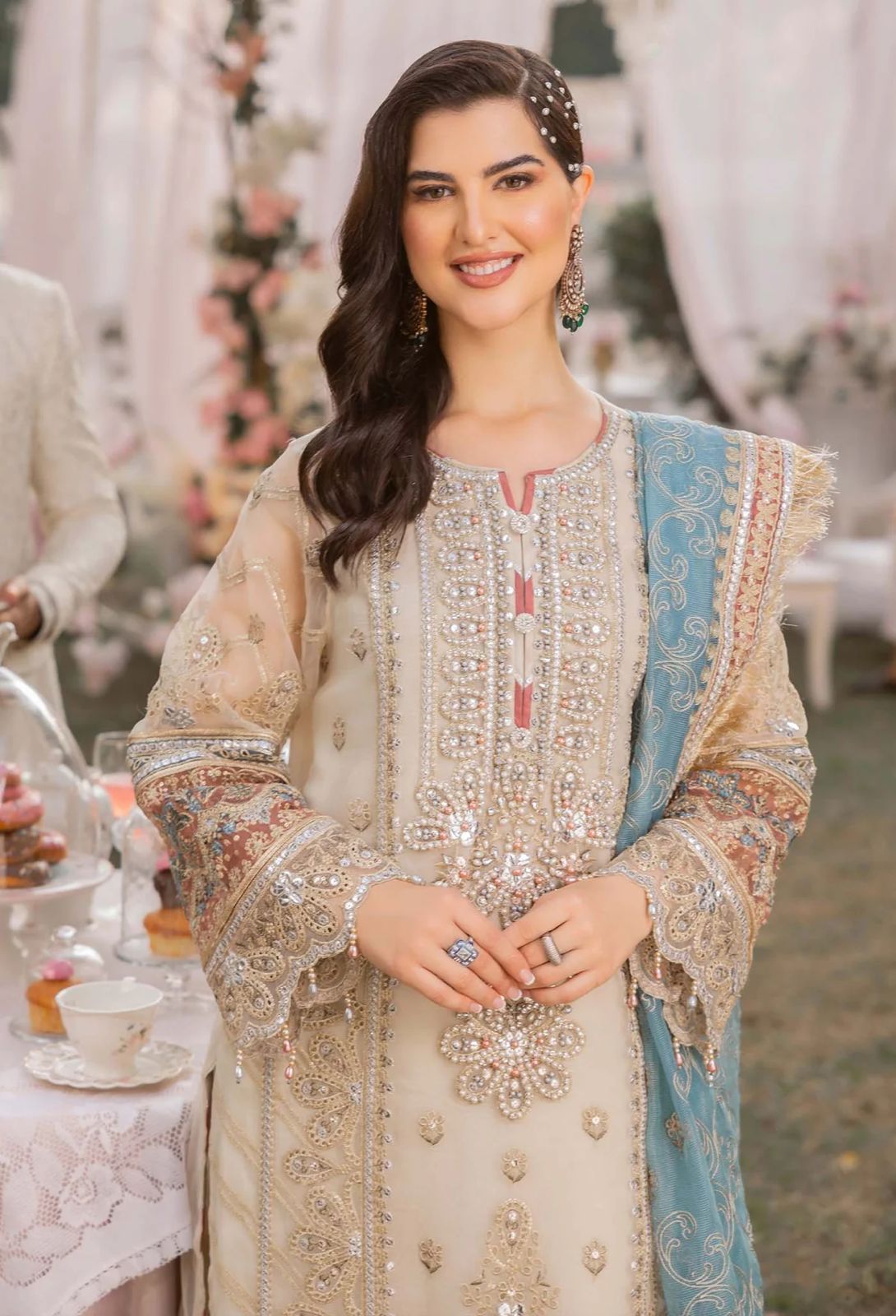 Woman in an ornate traditional outfit with a blurred background