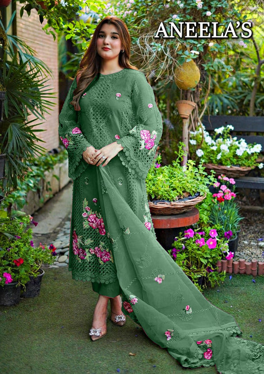 Woman wearing a green embroidered outfit with flowers in a garden setting, featuring the brand 'ANEELA'S'.