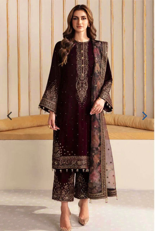 BAroque Jazmin Velvet Dress 2025 Woman wearing a Mehroon embroidered outfit with a matching dupatta in a neutral setting