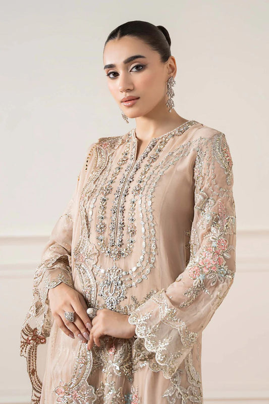 Maria b Formal & Wedding Woman wearing a beige embroidered dress with floral patterns on a light background