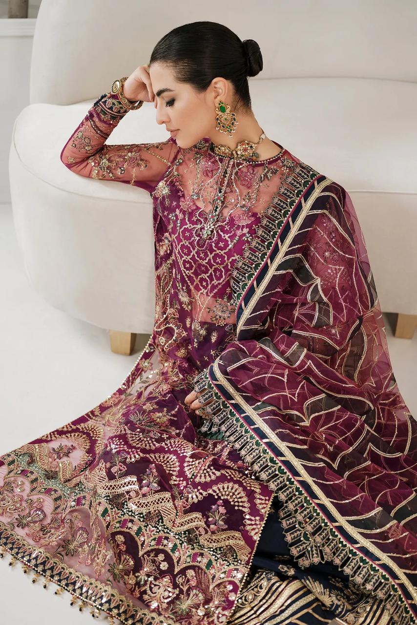 baroque gharara in a traditional embroidered outfit sitting on a white couch.