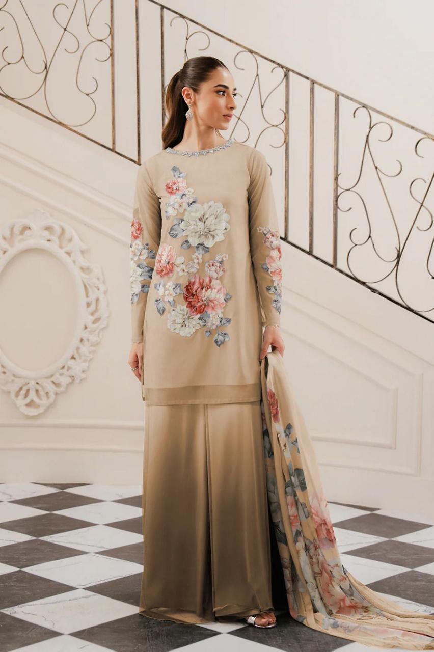 Lulusar Silk Dress Most Demanding Formal Wear in a beige traditional outfit with floral patterns in an elegant interior setting.
